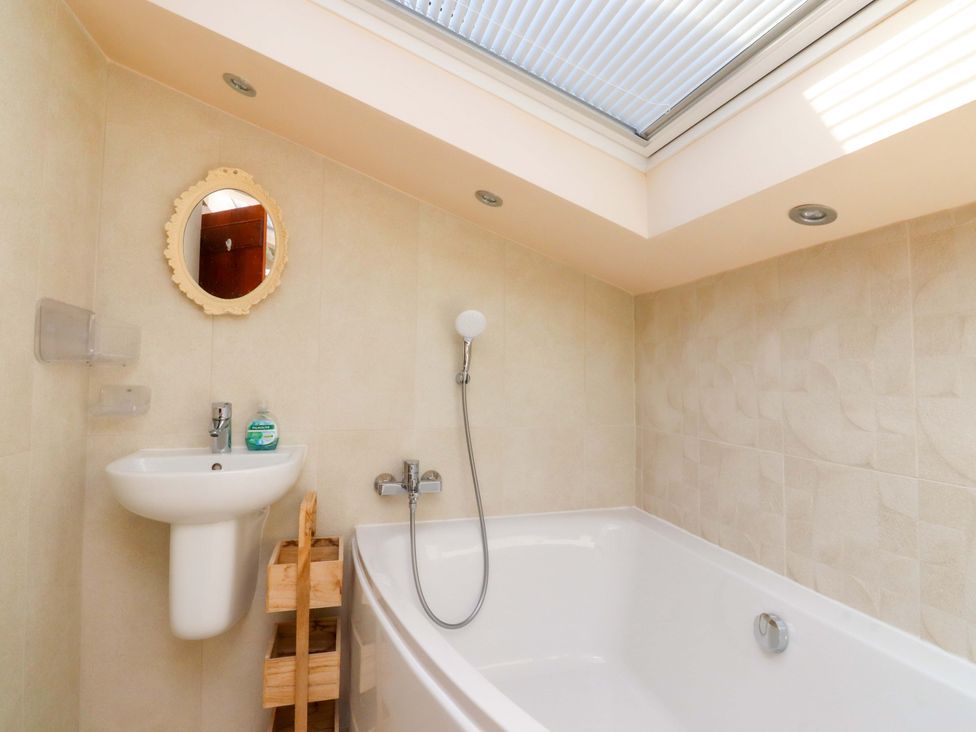 A bathroom with a bathtub and sink at Sheephouse Farm in Bacup