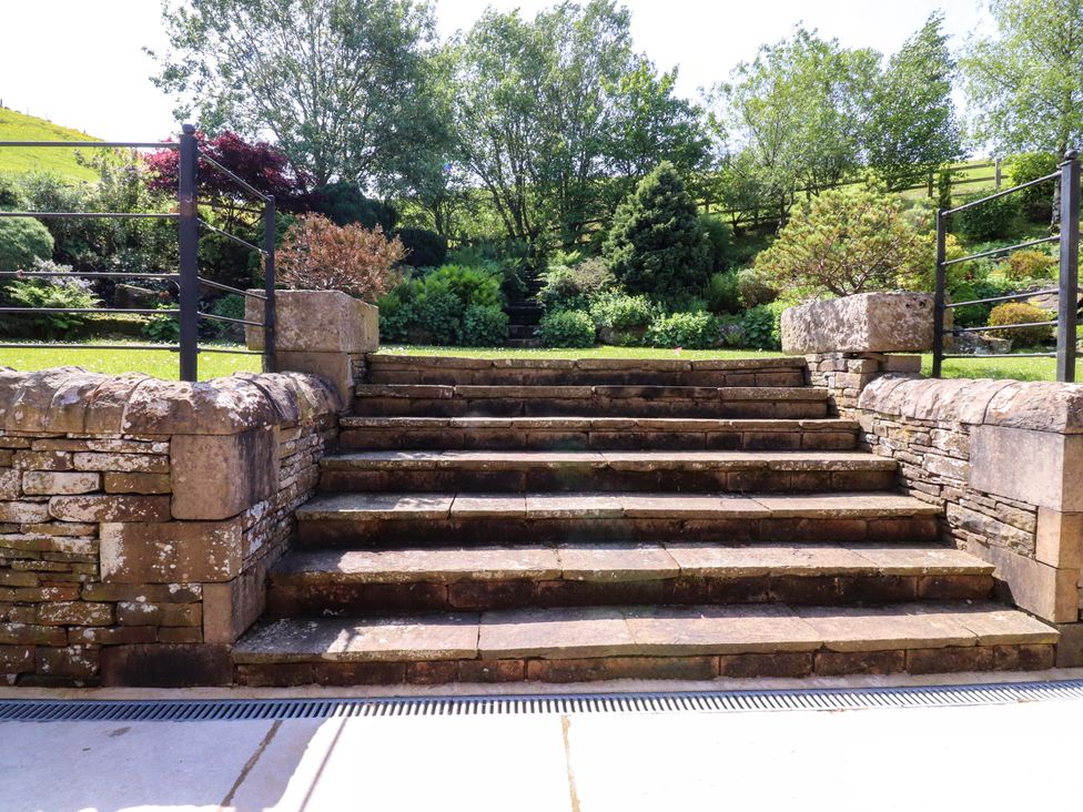 Steps leading to a garden area at Sheephouse Farm in Bacup
