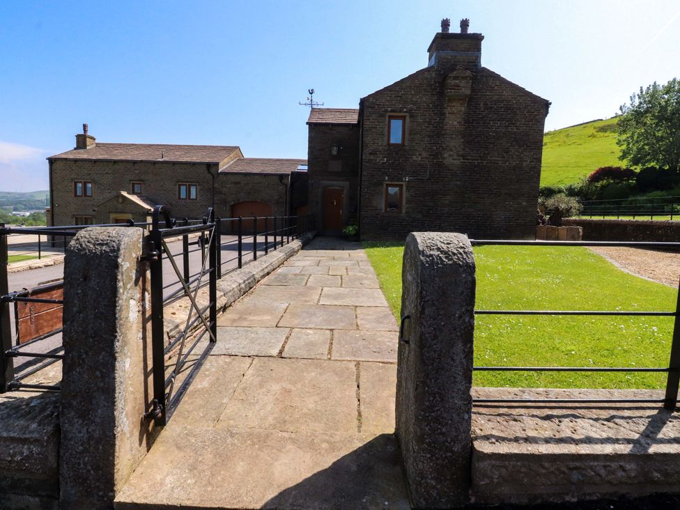 A house with a pathway and gate at Sheephouse Farm in Bacup