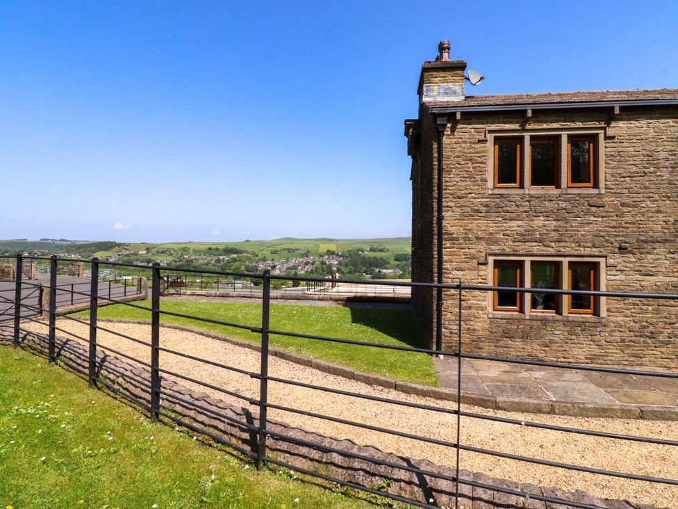 A house with a fence and grass at Sheephouse Farm in Bacup