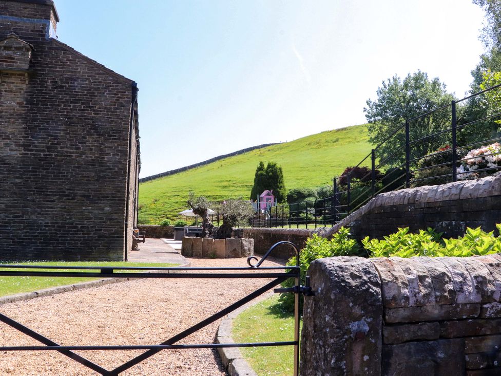 An outdoor area with a pathway and a gate at Sheephouse Farm in Bacup
