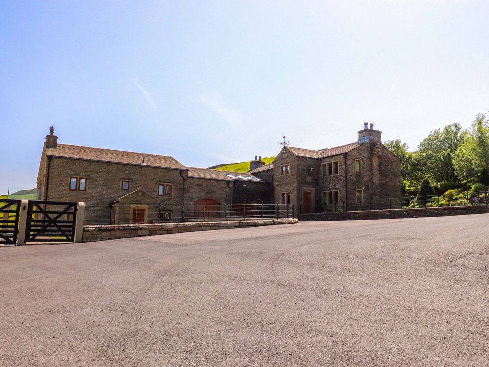 A house with a gate and parking area at Sheephouse Farm in Bacup