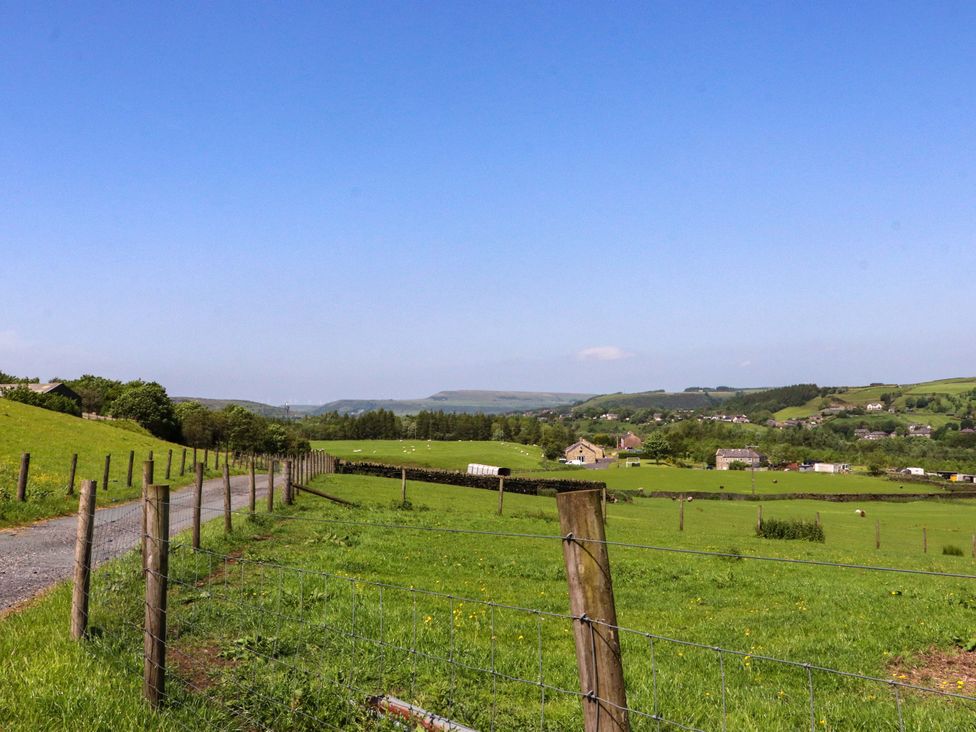 A landscape with a fence and road at Sheephouse Farm in Bacup