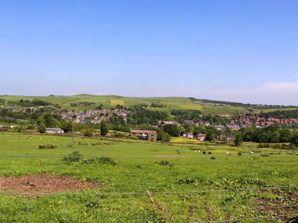 A landscape view with houses and sheep at Sheephouse Farm in Bacup