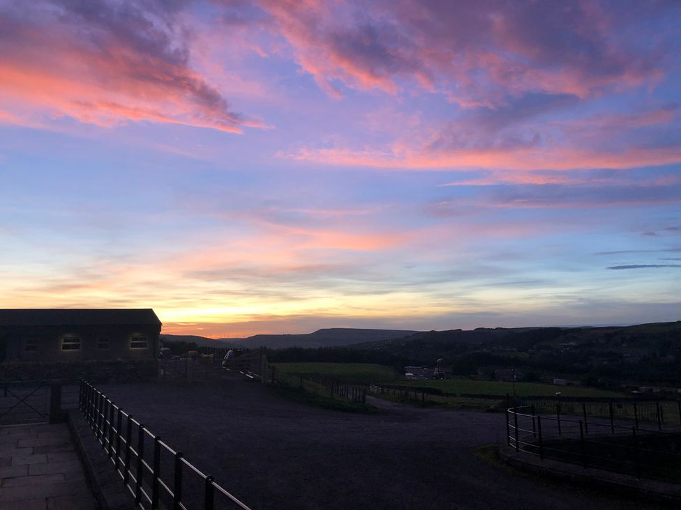 A sunset view with clouds and fields at Sheephouse Farm in Bacup