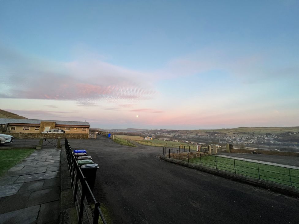 An outdoor view with buildings and trash bins at Sheephouse Farm in Bacup