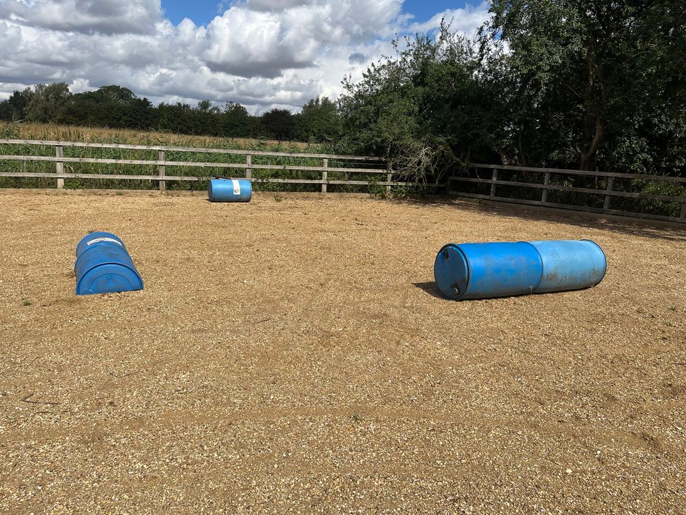 An outdoor area with blue barrels and gravel at Laurel in Littleport