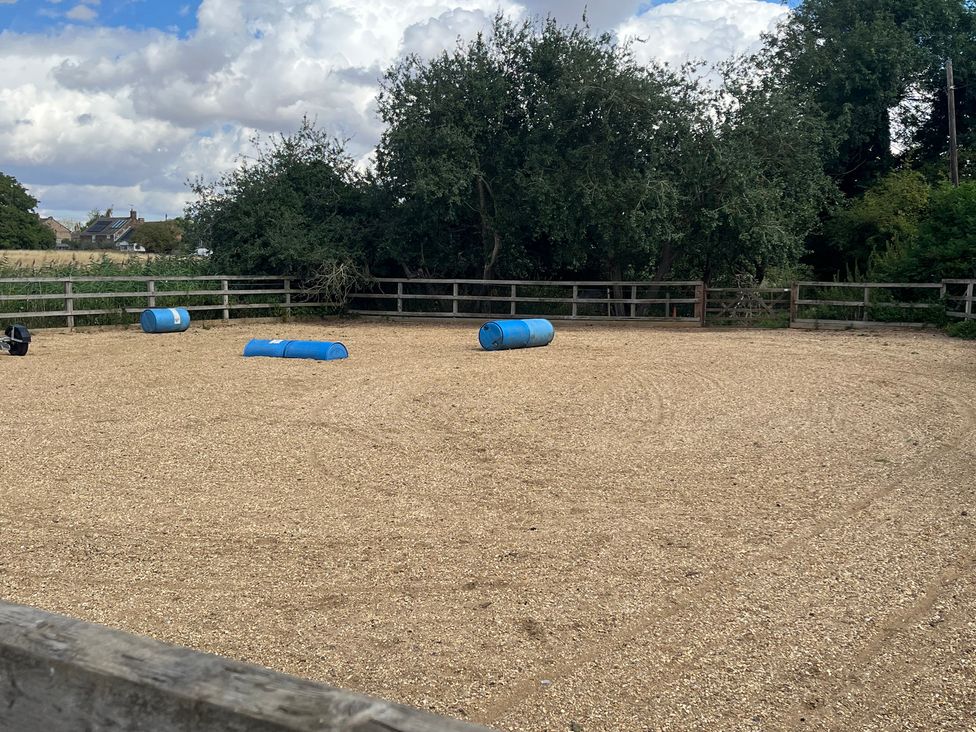 An outdoor equestrian area with barrels and a fence at Laurel in Littleport
