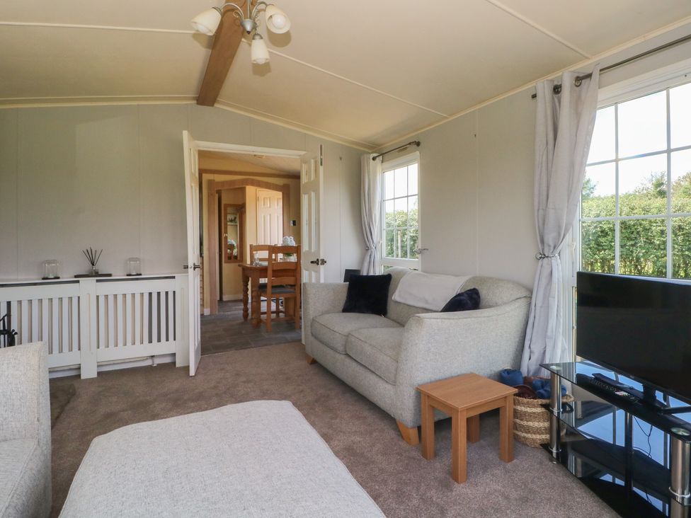A living room with a couch and coffee table at Hawks View Caravan Leek