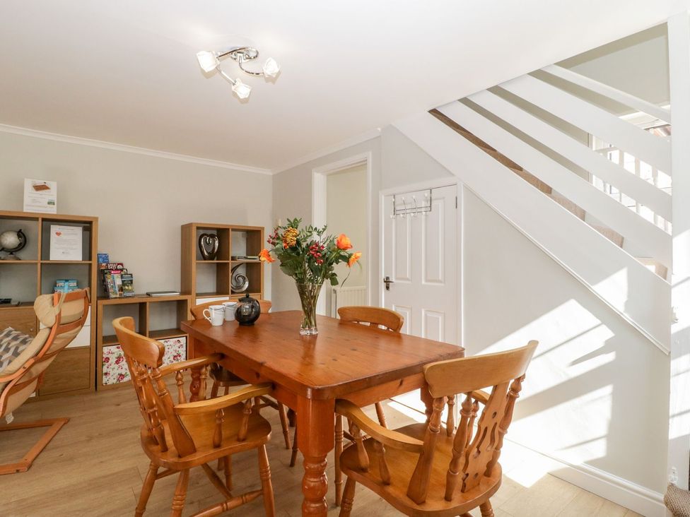 A dining room with a table and chairs at The Cottage in Winterslow