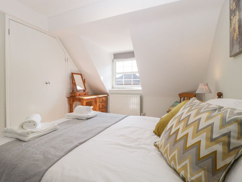A bedroom with a bed and dresser at The Cottage in Winterslow