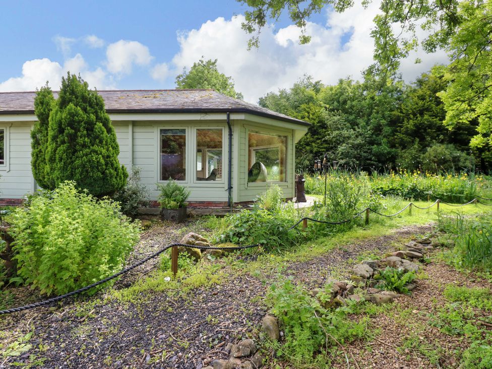 A cabin surrounded by a garden at Bull Rush Cabin Carwinley near Longtown