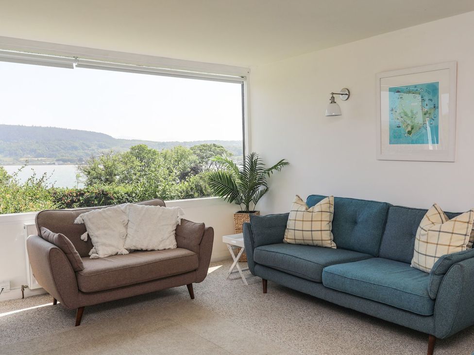 A living room with a sofa and a view at Bryn Llifon in Pentraeth