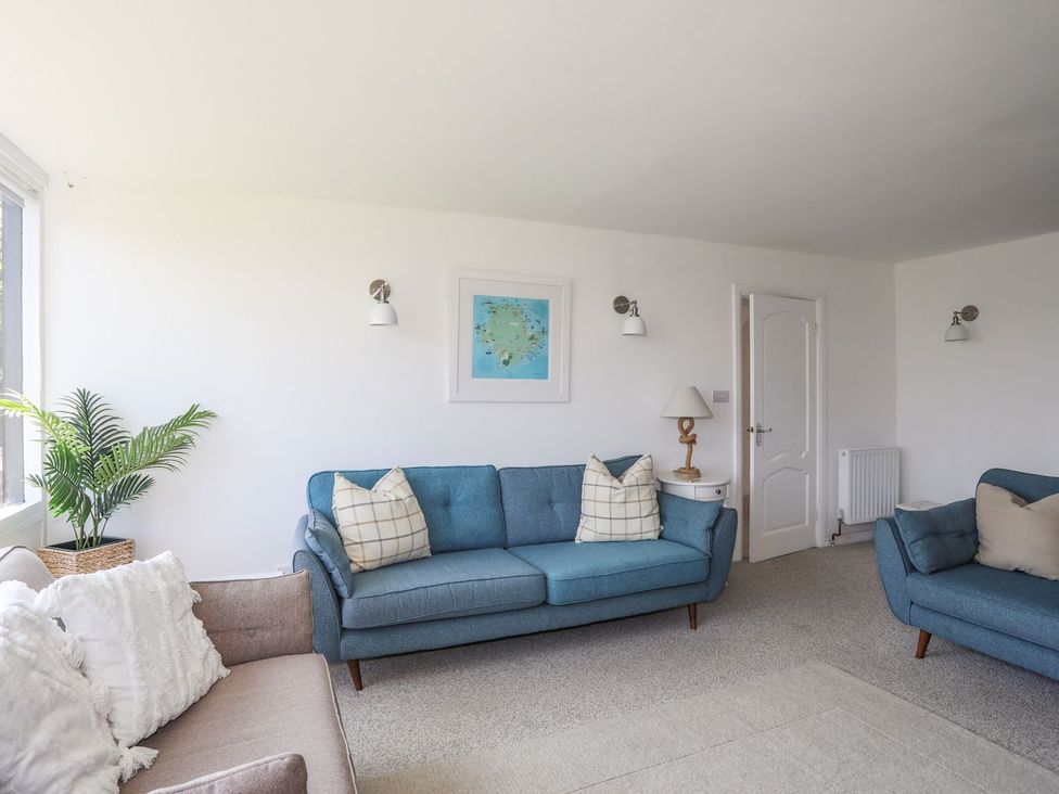 A living room with sofas and decor at Bryn Llifon in Pentraeth