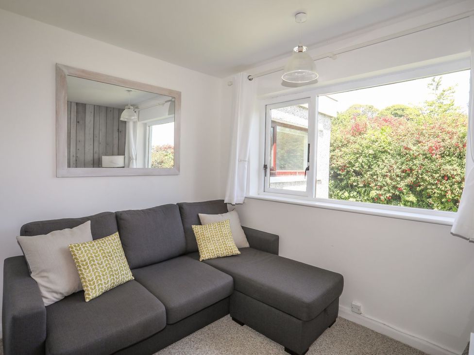 A living room with a sofa and a window at Bryn Llifon in Pentraeth