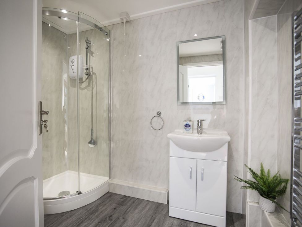 A bathroom with a shower and sink at Bryn Llifon in Pentraeth