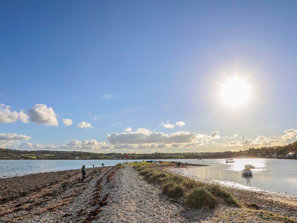 A river with boats on the shore at Bryn Llifon in Pentraeth