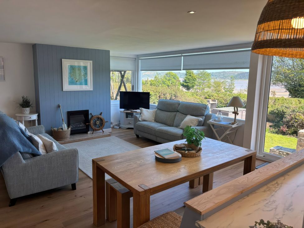 A living room with a sofa and coffee table at Red Wharf Retreat near Red Wharf Bay