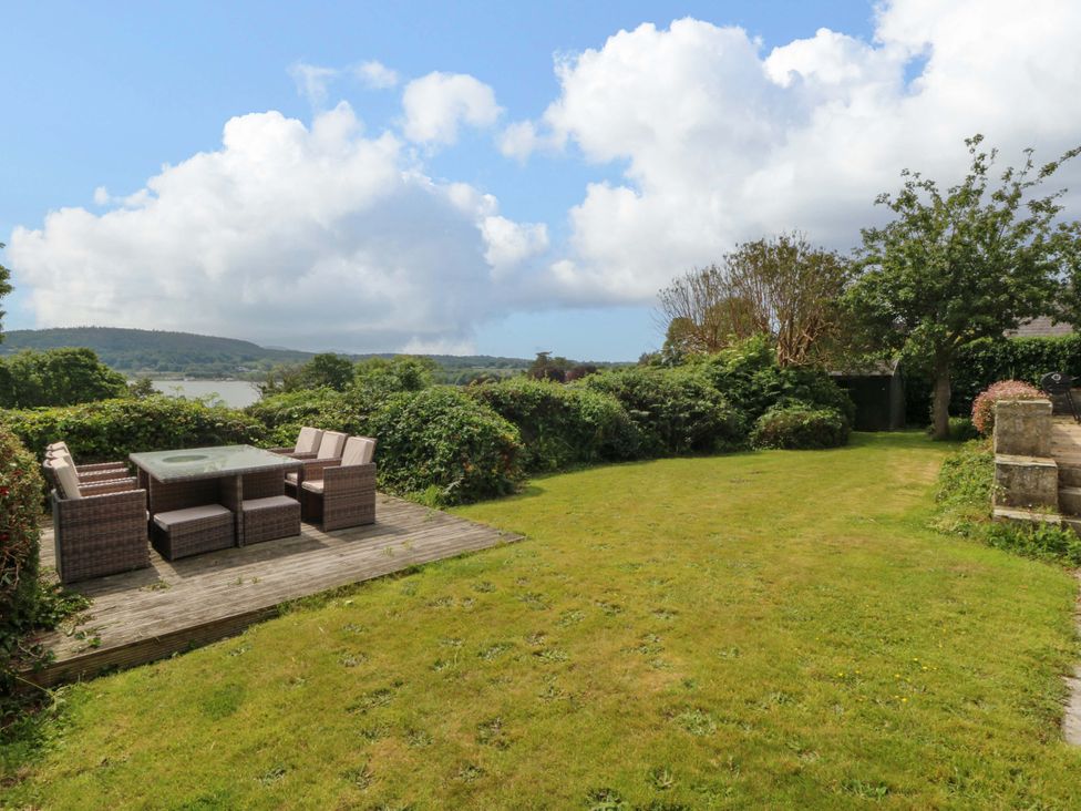 A garden with seating area at Red Wharf Retreat near Red Wharf Bay