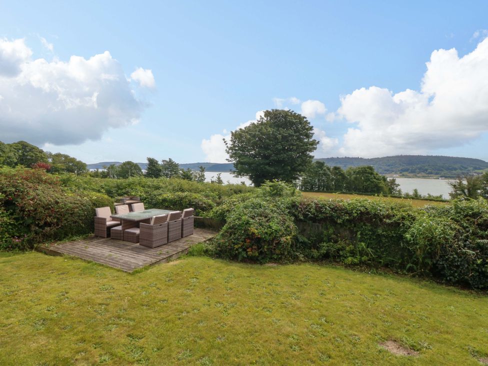 A garden with outdoor furniture at Red Wharf Retreat in Red Wharf Bay near Benllech