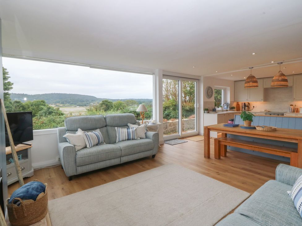 A living room with a sofa and table at Red Wharf Retreat Red Wharf Bay near Benllech