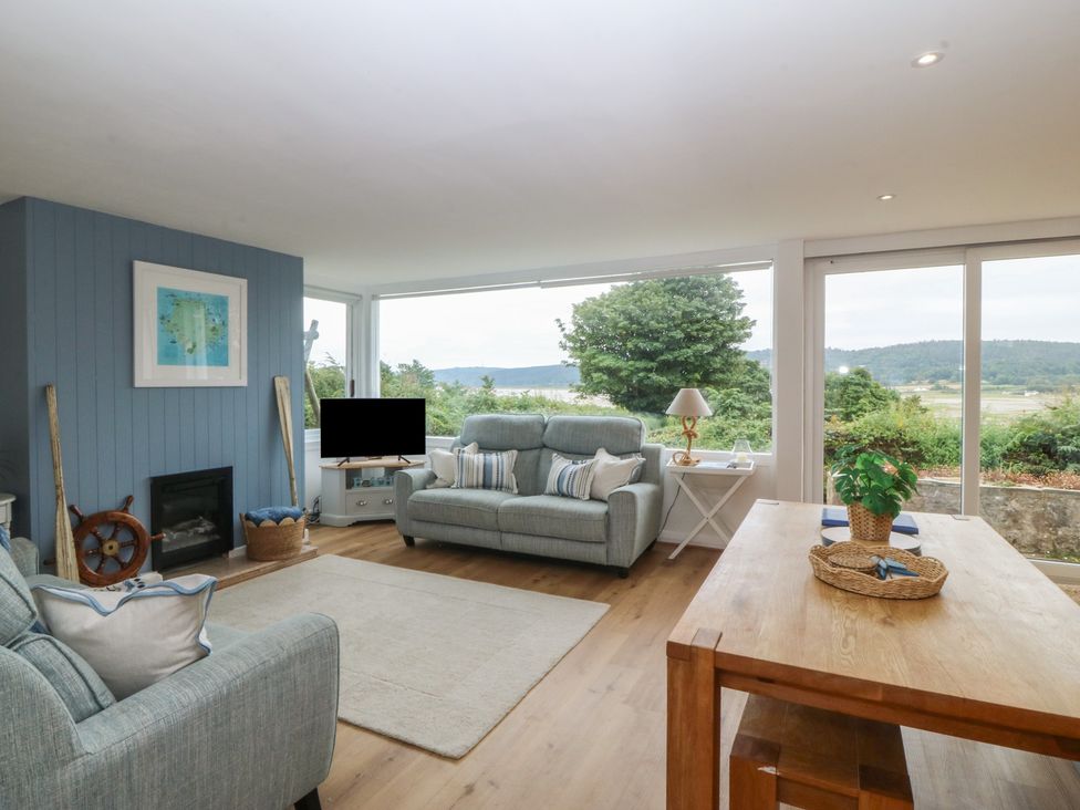 A living room with a sofa and a coffee table at Red Wharf Retreat near Red Wharf Bay