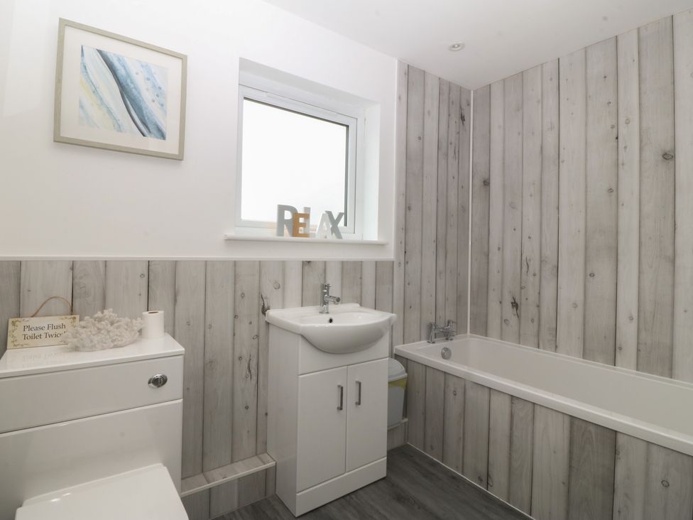 A bathroom with a sink and bathtub at Red Wharf Retreat in Red Wharf Bay near Benllech