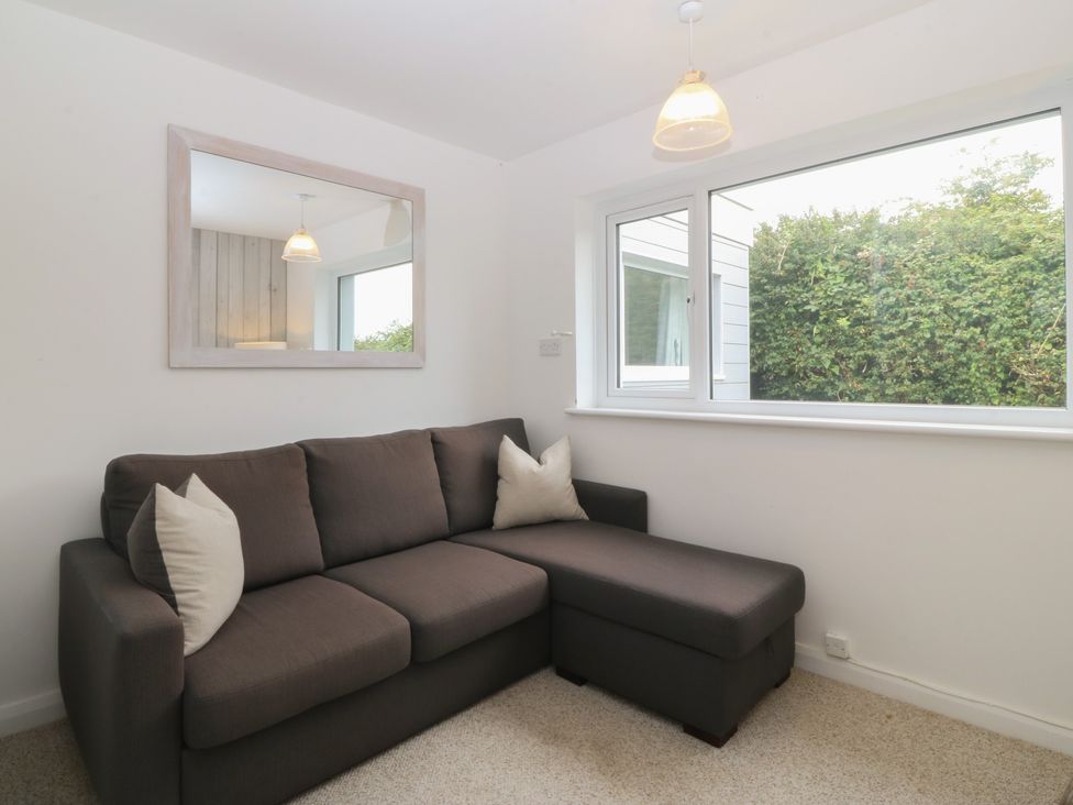 A living room with a sofa and window at Red Wharf Retreat Red Wharf Bay near Benllech