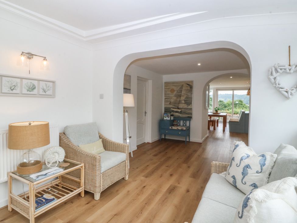 A living room with a sofa and armchair at Red Wharf Retreat near Red Wharf Bay