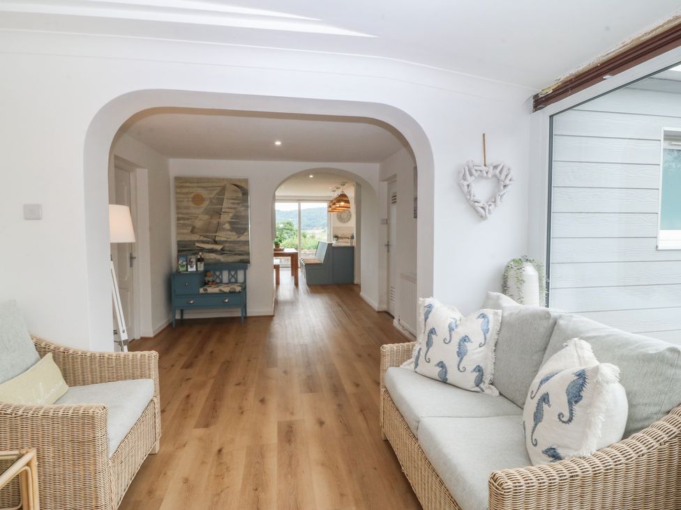 A living room with a sofa and armchair at Red Wharf Retreat near Red Wharf Bay