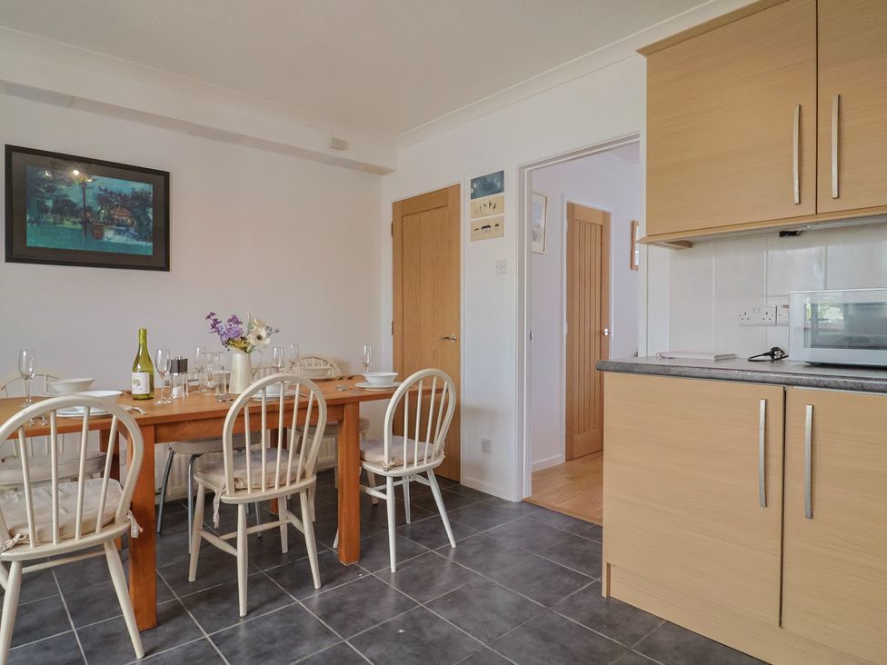 A dining room with a wooden table and chairs at Seaview in Lyme Regis