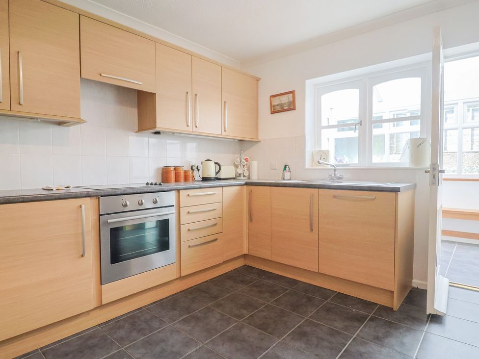 A kitchen with cabinets oven and sink at Seaview in Lyme Regis