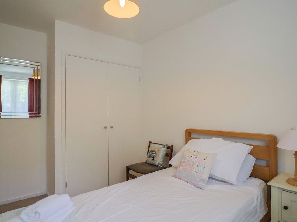 A bedroom featuring a bed and a wardrobe at Seaview in Lyme Regis