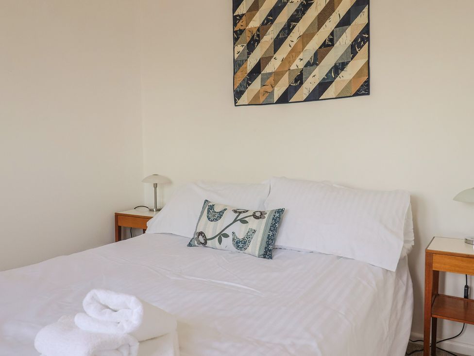 A bedroom with a bed and nightstand at Seaview in Lyme Regis