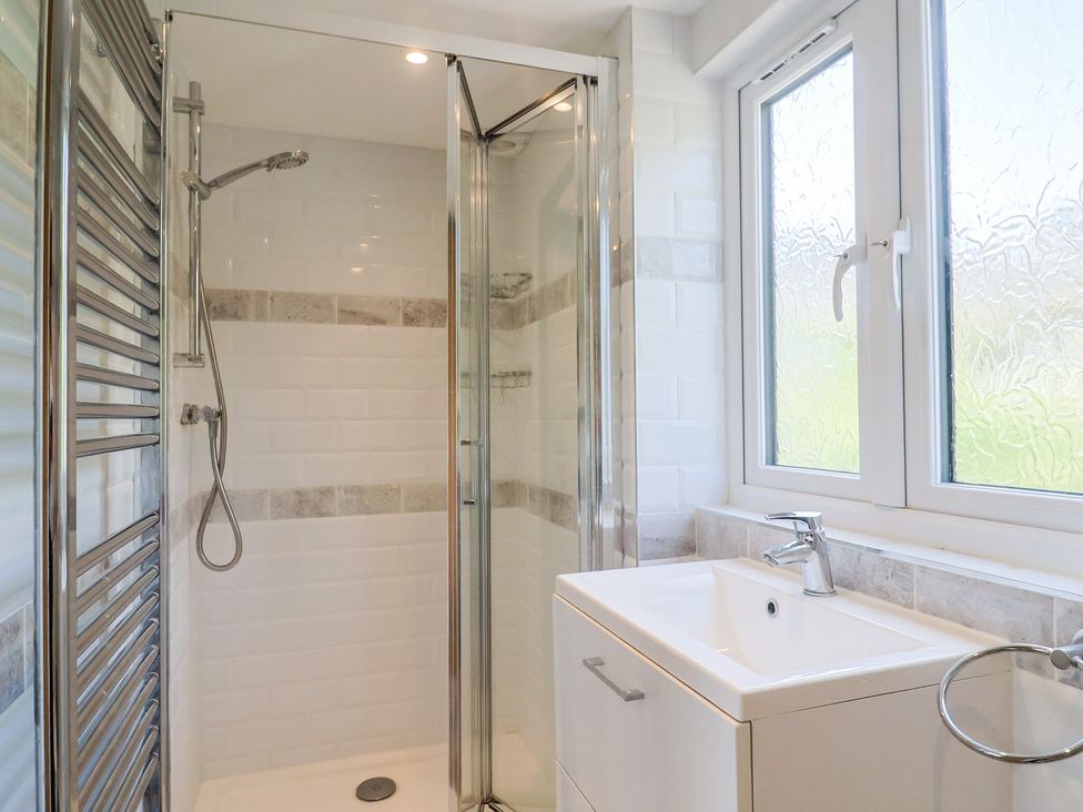 A bathroom with a shower and sink at Seaview in Lyme Regis