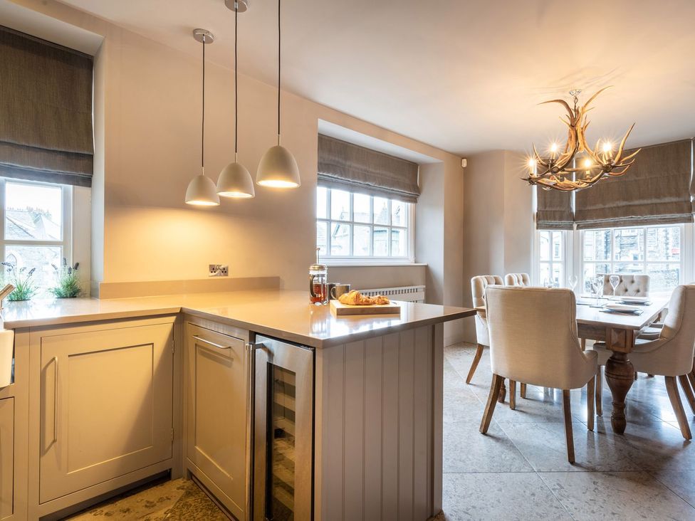 A kitchen with a countertop and dining table at Prospect House in Windermere