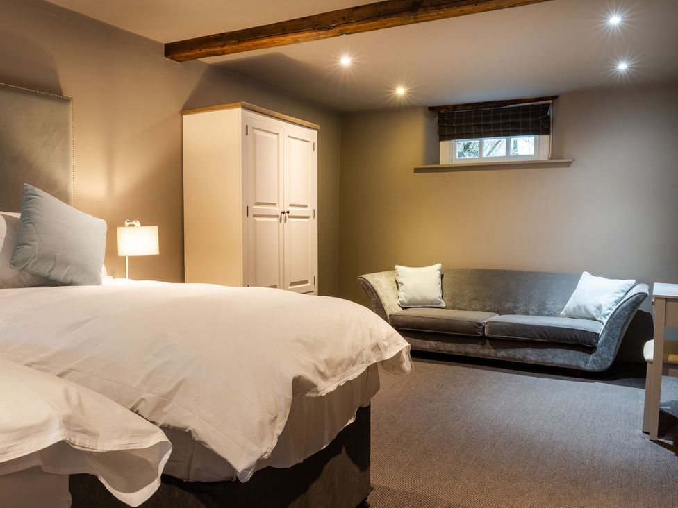 A bedroom with a bed and wardrobe at Prospect House in Windermere