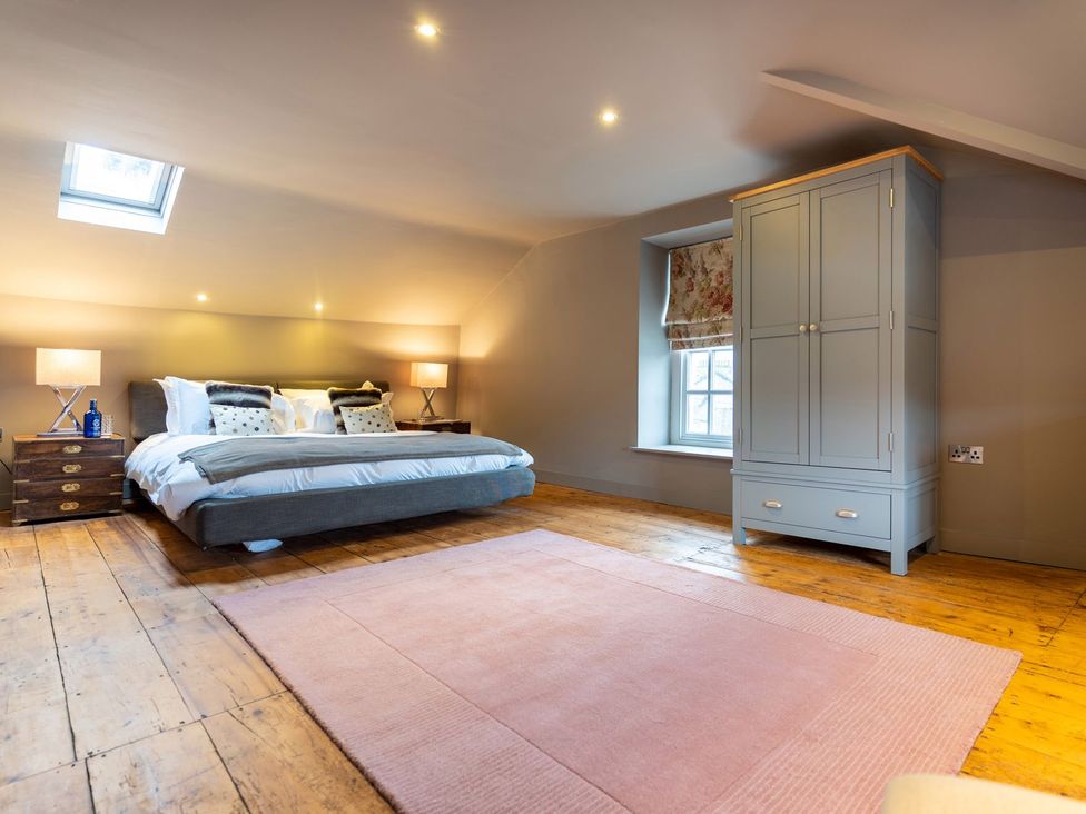 A bedroom with a bed and wardrobe at Prospect House in Windermere