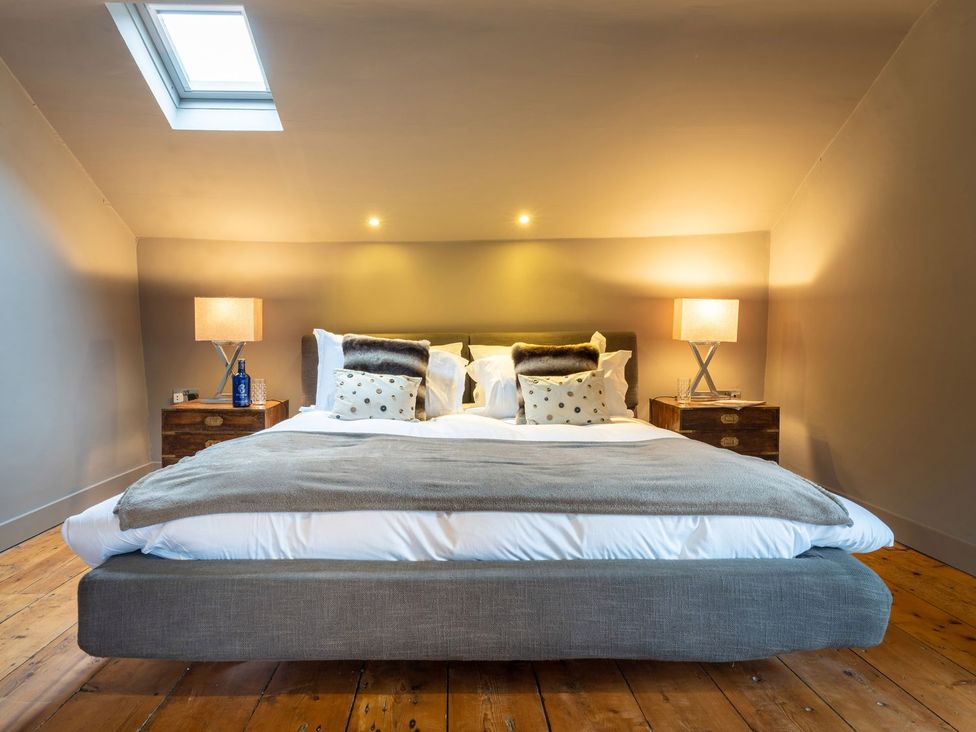 A bedroom with a bed and nightstands at Prospect House in Windermere