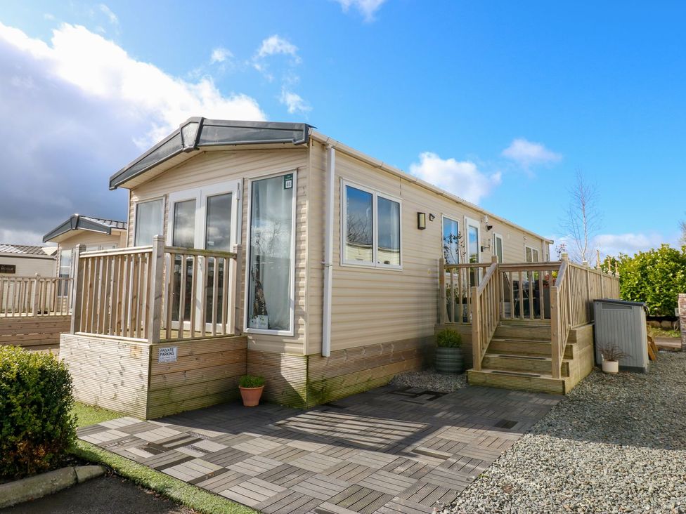A mobile home with a deck and steps at Plot 41 High Hesket near Armathwaite