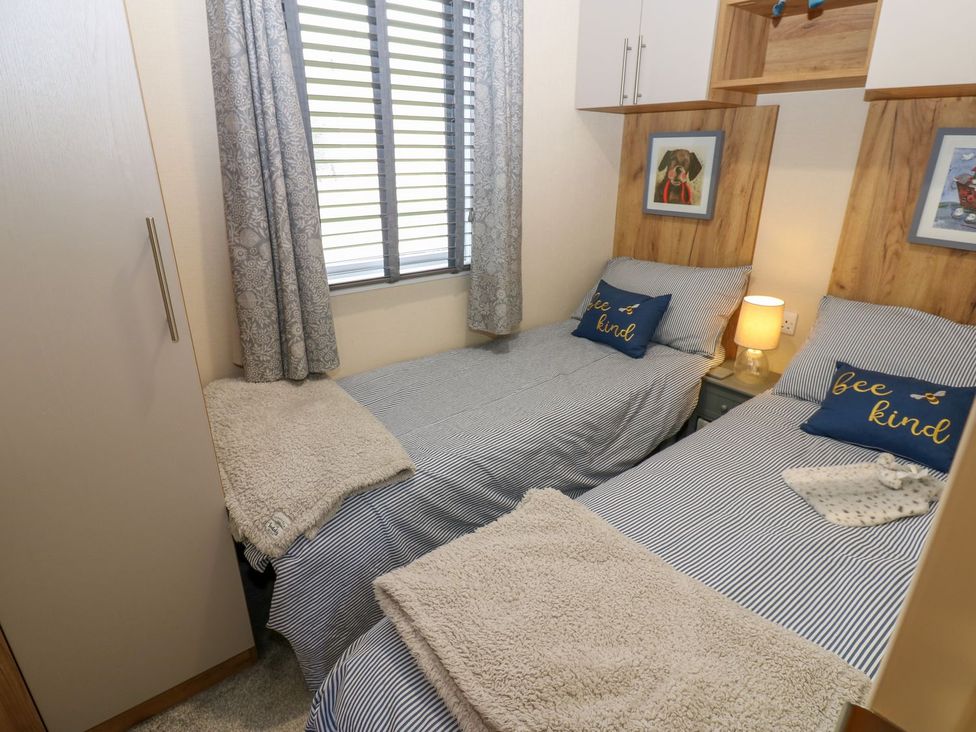 A bedroom with two single beds and wardrobe at Plot 41 High Hesket near Armathwaite