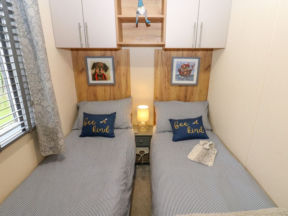 A bedroom with two beds and wall art at Plot 41 High Hesket near Armathwaite