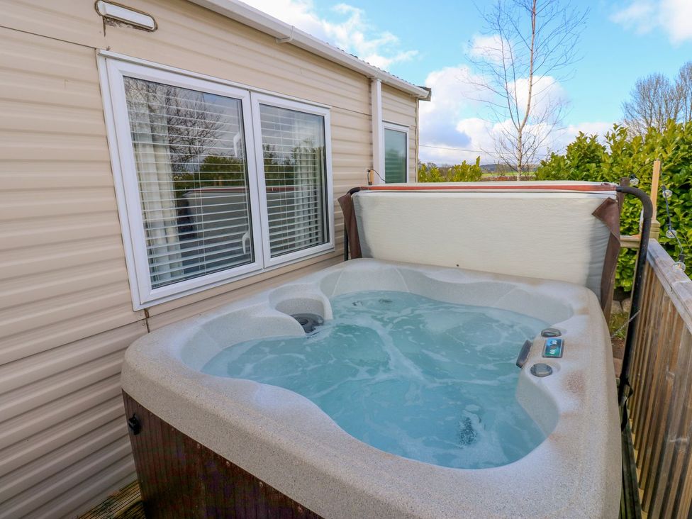 A hot tub with water in an outdoor area at Plot 41 High Hesket near Armathwaite