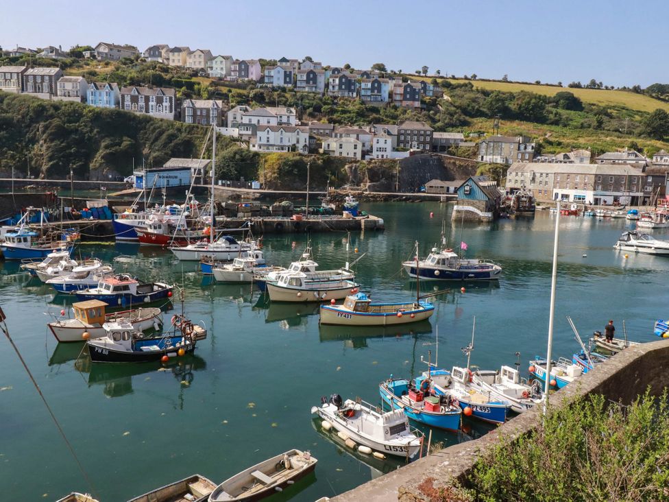 A harbor with boats and buildings in the background at Stones Throw Mevagissey