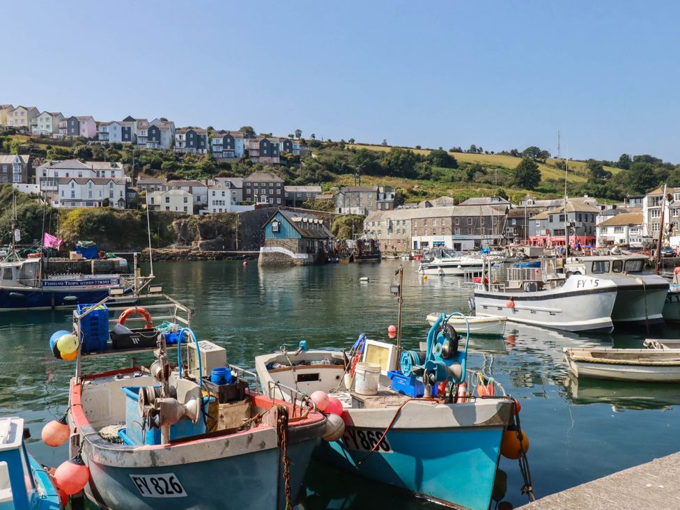 A harbor with boats and buildings in the background at Stones Throw Mevagissey