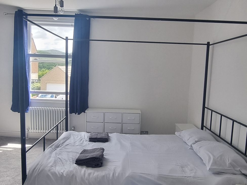 A bedroom with a bed and a window at 3 Greystone Terrace Cleator Moor