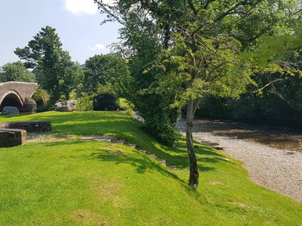 A riverside scene with a bridge and greenery at 3 Greystone Terrace Cleator Moor