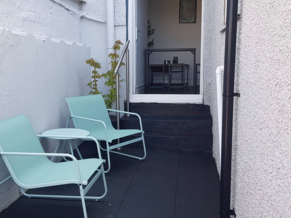 Two chairs and a table in an outdoor area at 3 Greystone Terrace Cleator Moor