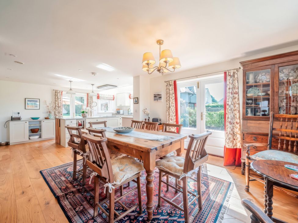 A kitchen with a dining table and chairs at TBC 