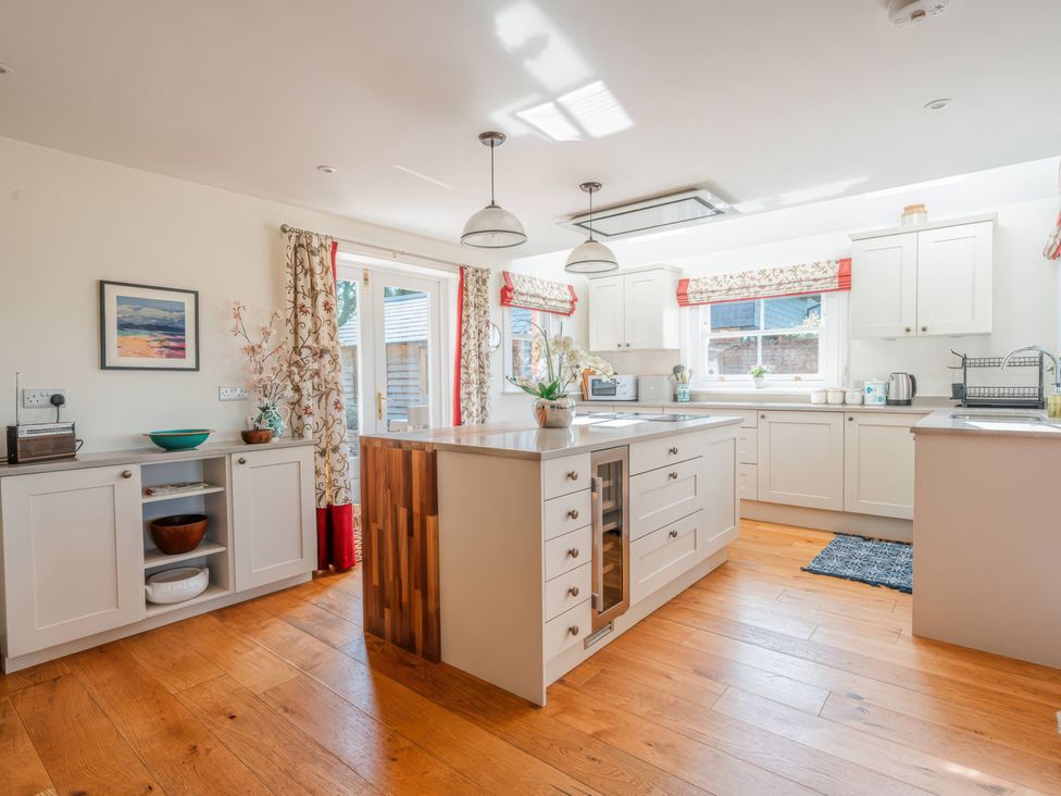 A kitchen with an island and cabinets at TBC